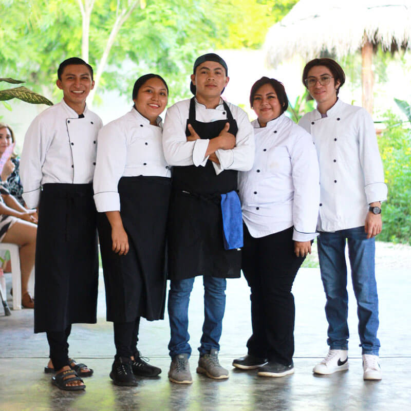 Five chefs posing for a photo.